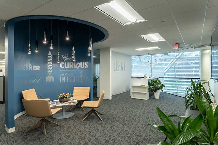 THD’s well-lit lobby with a crescent blue wall with words written in silver